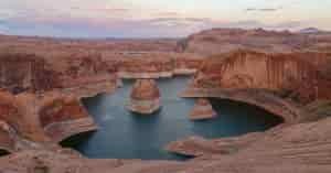 an aerial view of reflection canyon with rocks in a circle shape and water between them