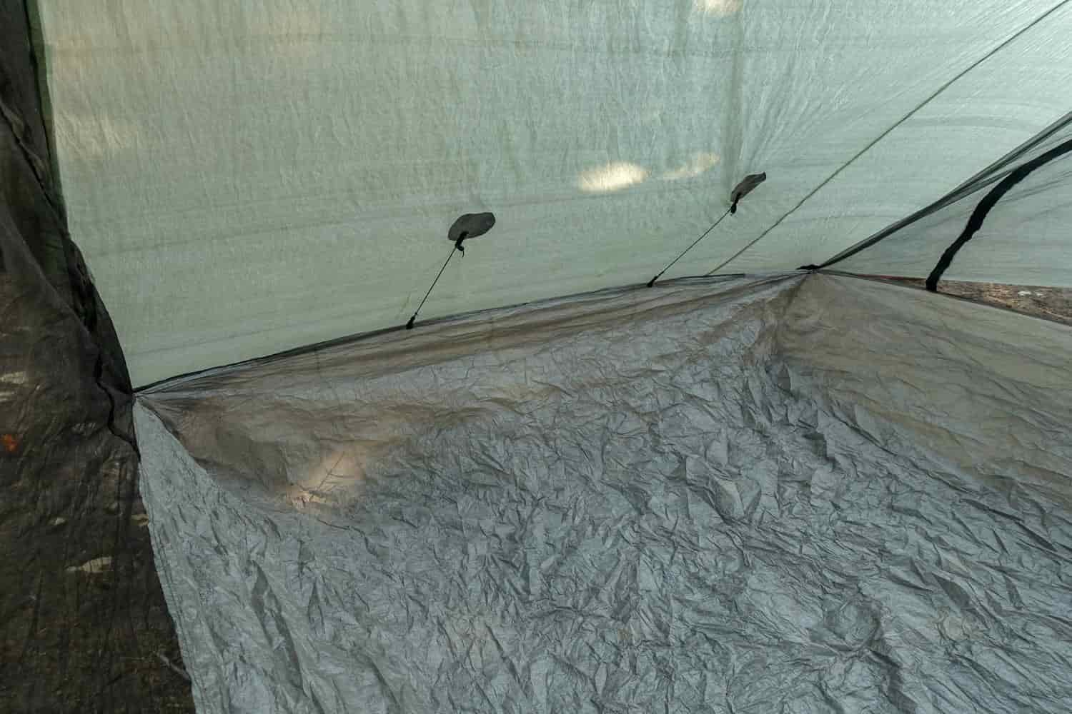 the inside view of the zpacks classic triplex ultralight backpacking tent with internal guylines to pull the exterior screen doors away from rain spray