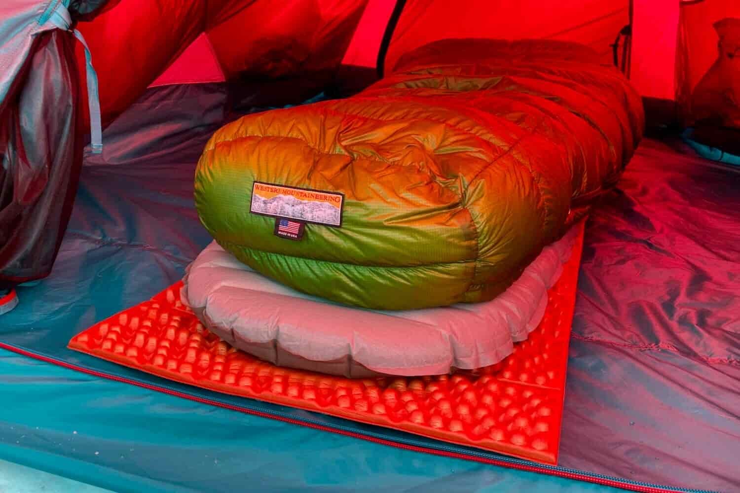 Closeup-of-a-winter-camping-sleep-systeWestern-Mountaineering-Versalite-10F-sleeping-bag-Therm-a-Rest-NeoAir-XTherm-and-NEMO-Switchback-sleeping-pads