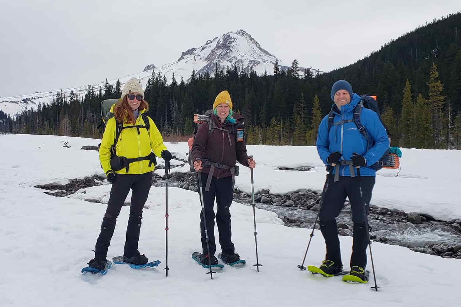Three-well-equipped-winter-campers-posing-for-a-photo-in-front-of-Mt-Hood