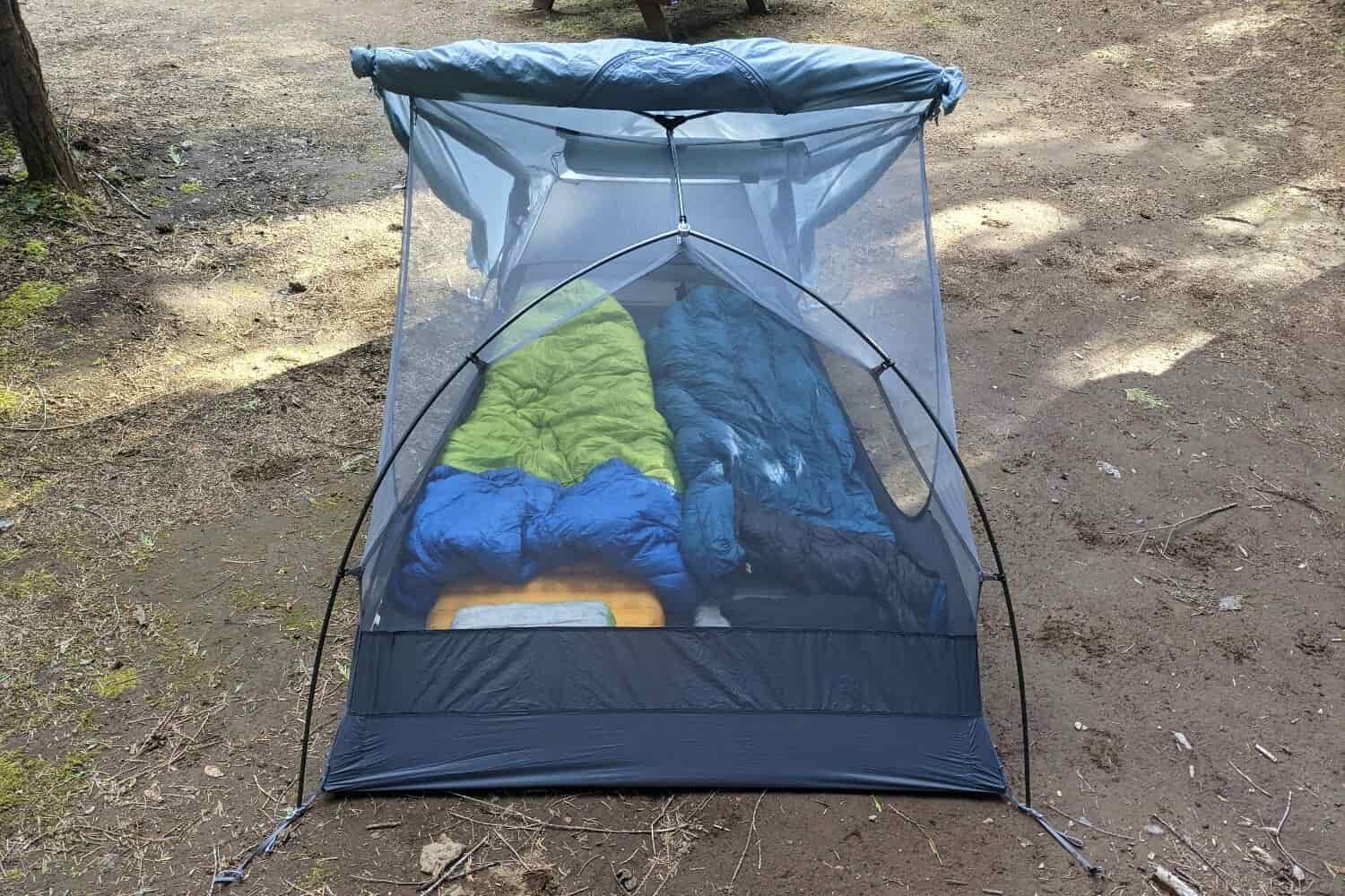 a sea to summit backpacking tent set up without the rainfly to show two sleeping bags and pads set up inside