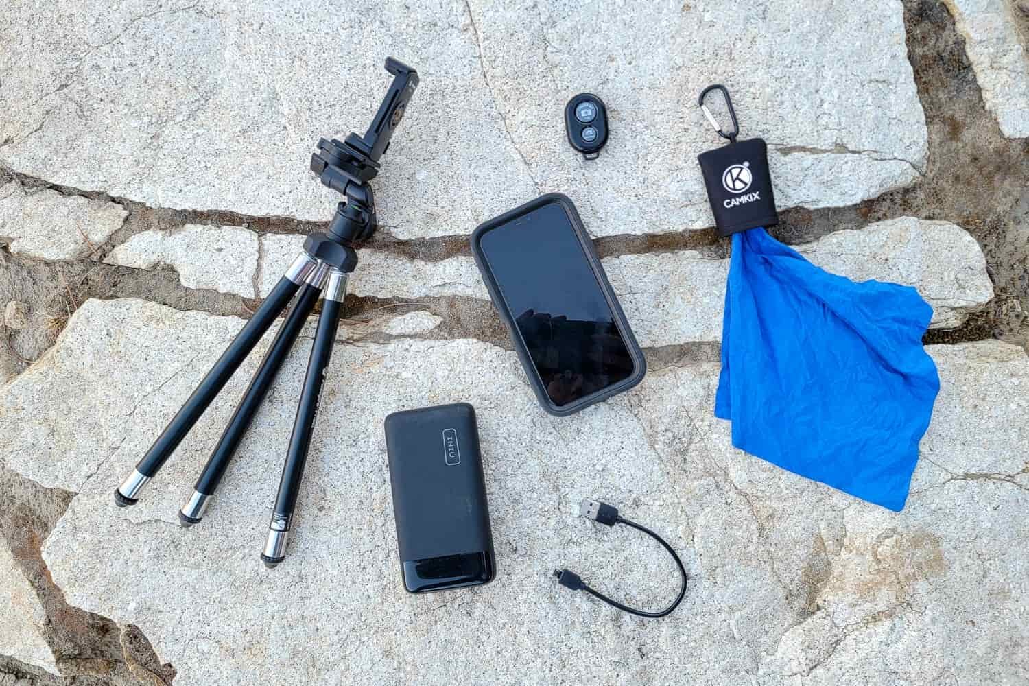 Cell phone accessories spread out on a rock