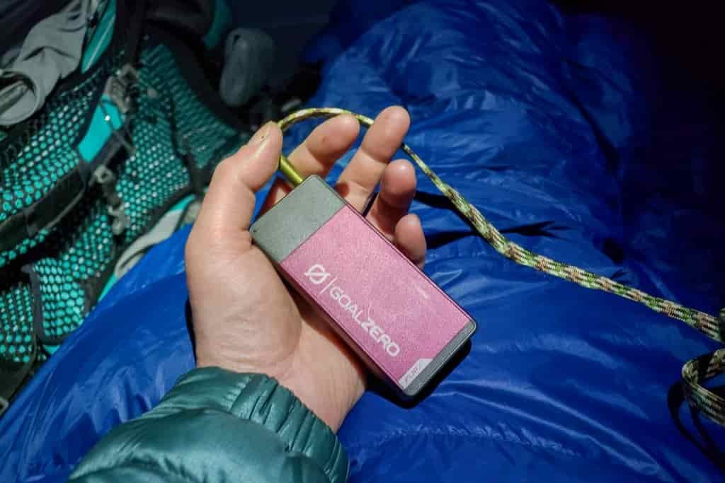 Close up of a battery charger in a women's hand in her tent