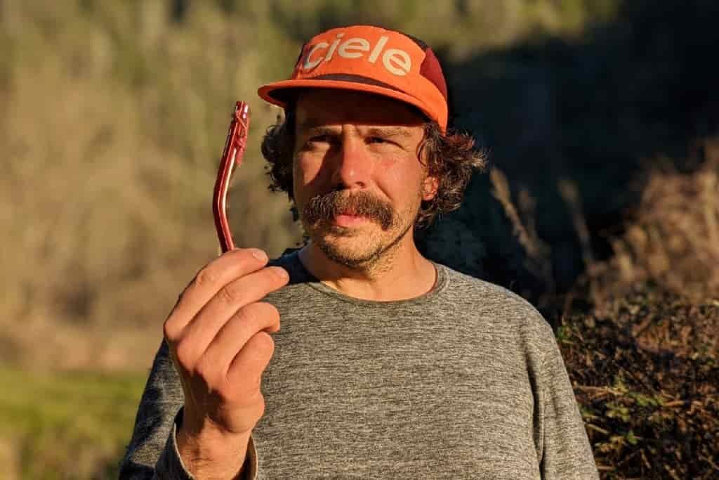 person holding a bent tent stake