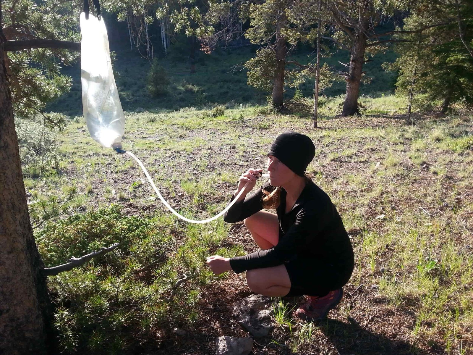 backpacker using their gravityworks as a hydration bladder