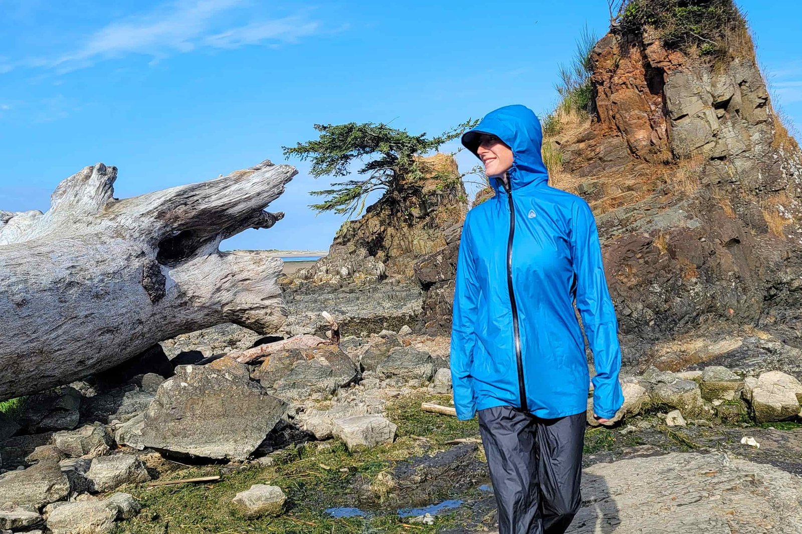 a hiker on the oregon coast wearing their zpacks vertice rainjacket