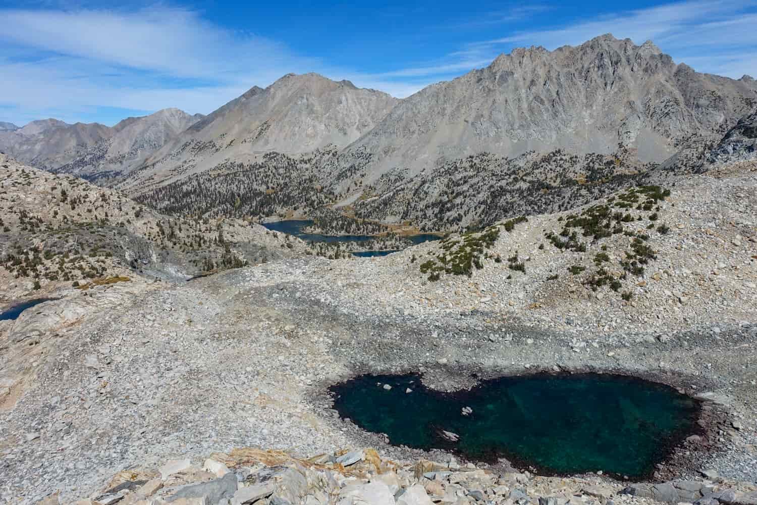 small lake below a mountain pass on the John Muir Trail.