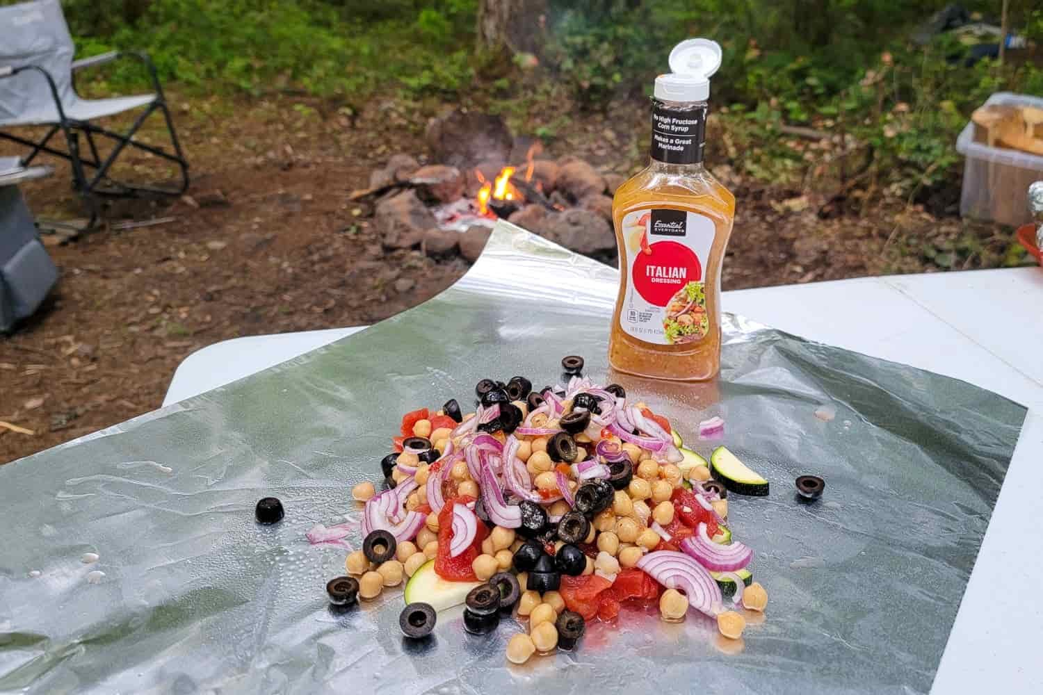 raw ingredients and a dressing on aluminum foil