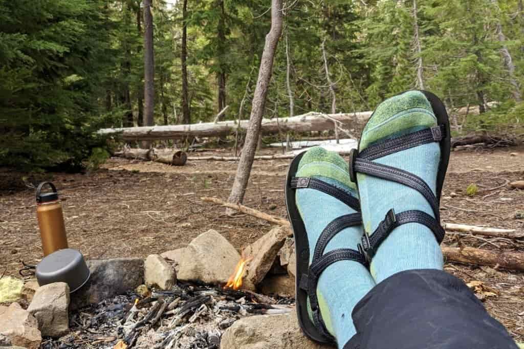 A hiker with six bandages on her feet where her hiking sandals rub her skin