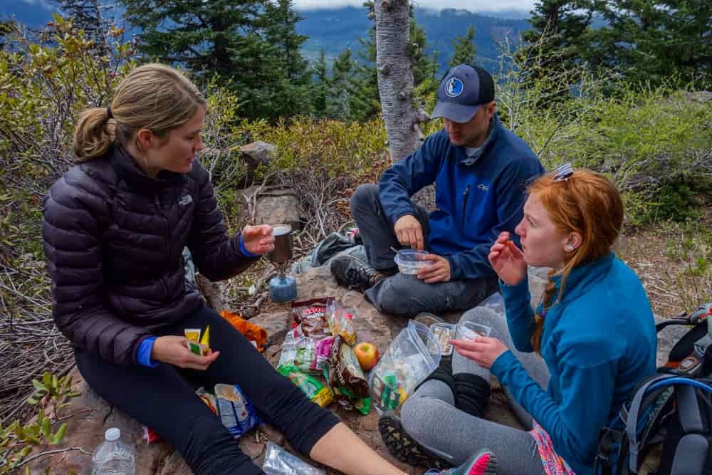 group of backpackers eating food