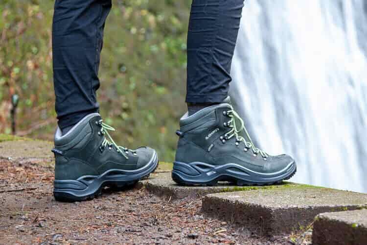 a close up of green low renegades in front of a waterfall
