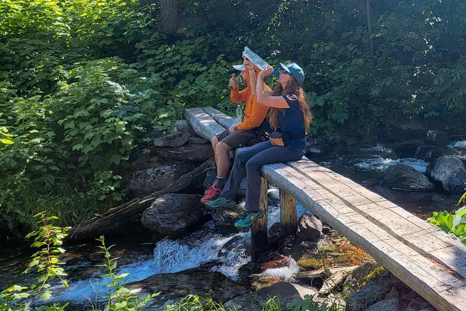 A backpacker drinking straight out of the Platypus QuickDraw