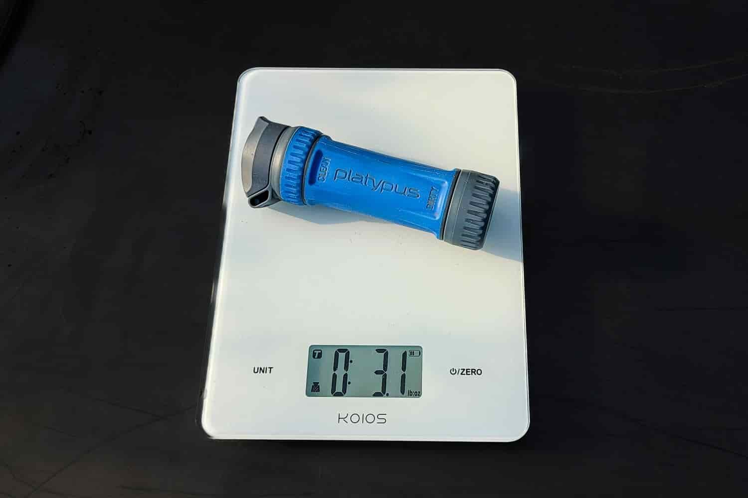 a platypus quickdraw being weighed on a scale. 
