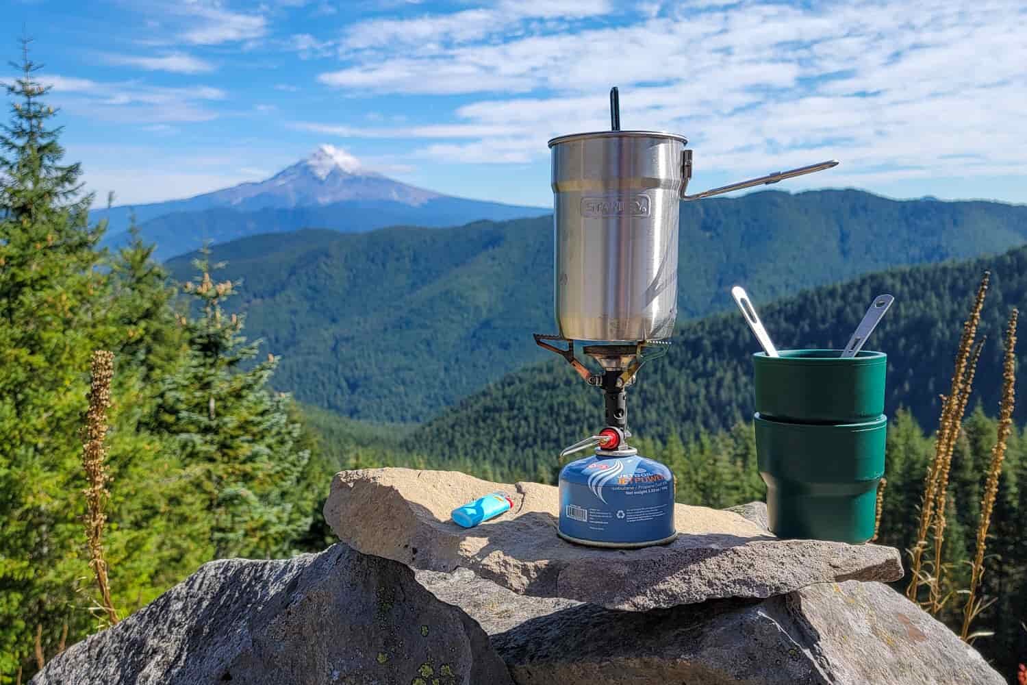 stanley adventures nesting 2 cup cookset set on a rock overlooking a pacific northwest view