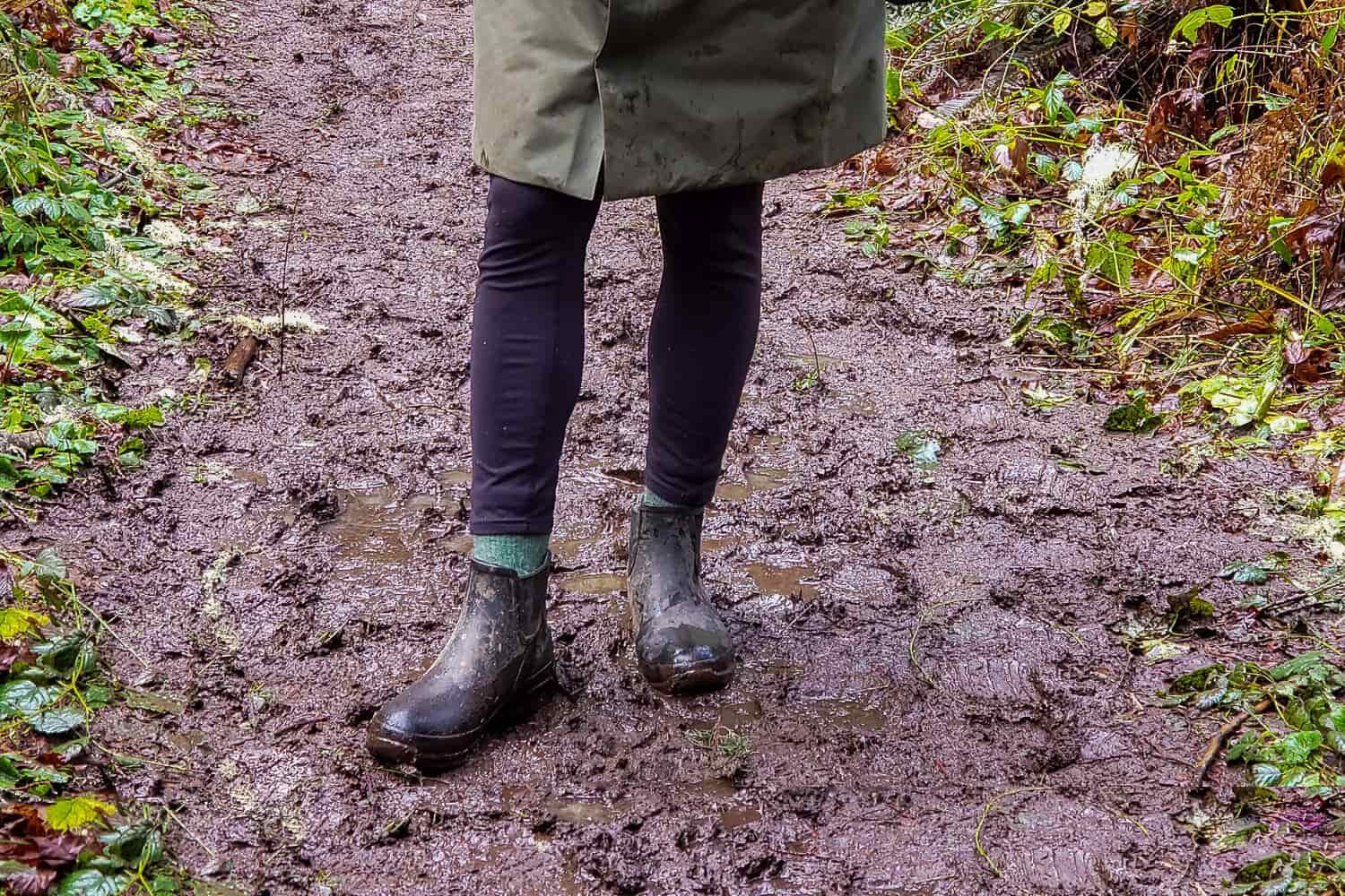 Walking-on-a-muddy-trail-in-the-Bogs-Amanda-Plush-Slip-On-Boots
