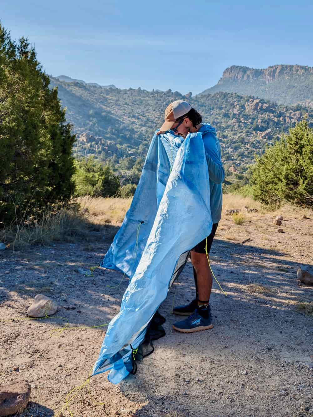 A backpacker holding the loose Zpacks Duplex Zip tent in his hands demonstrating how to shake it out