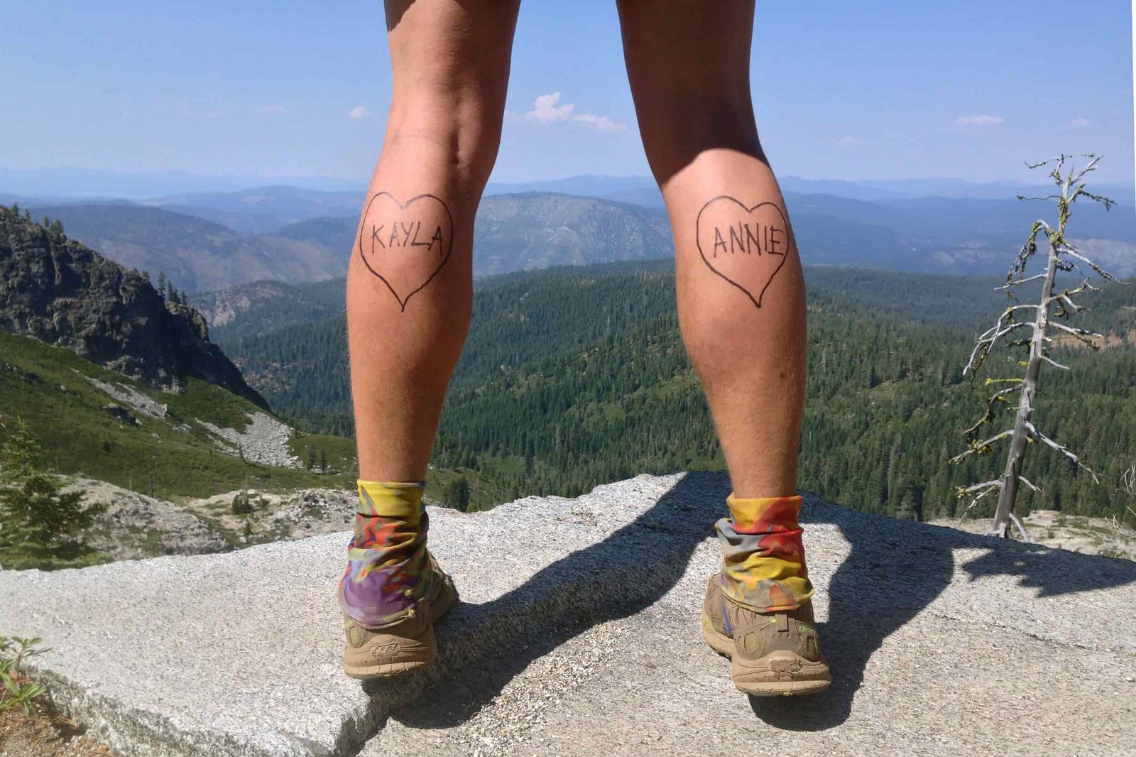 Rearview pictures of a hiker's calves with the names "Kayla" and "Annie" written inside hearts