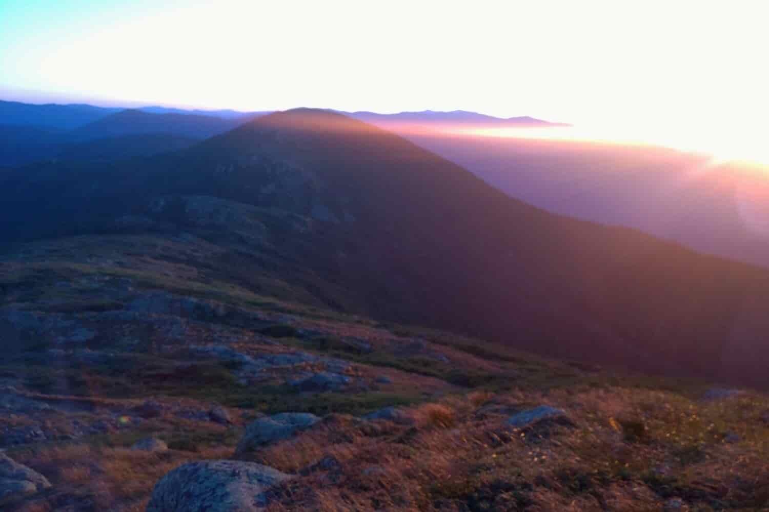 sun setting on a mountain top