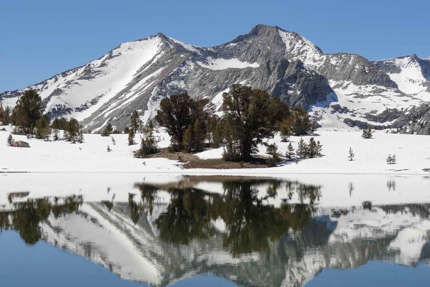 snowy mountain reflected in an alpine lake