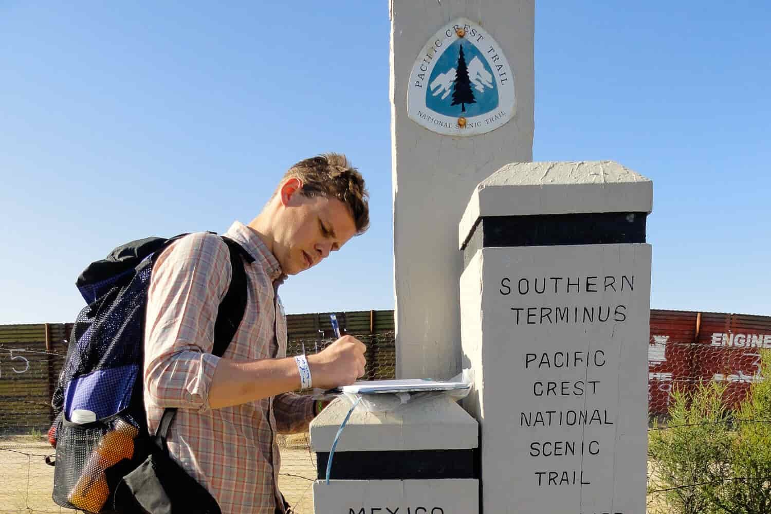 Thru-hiker signs the log book at the southern terminus of the Pacific Crest Trail