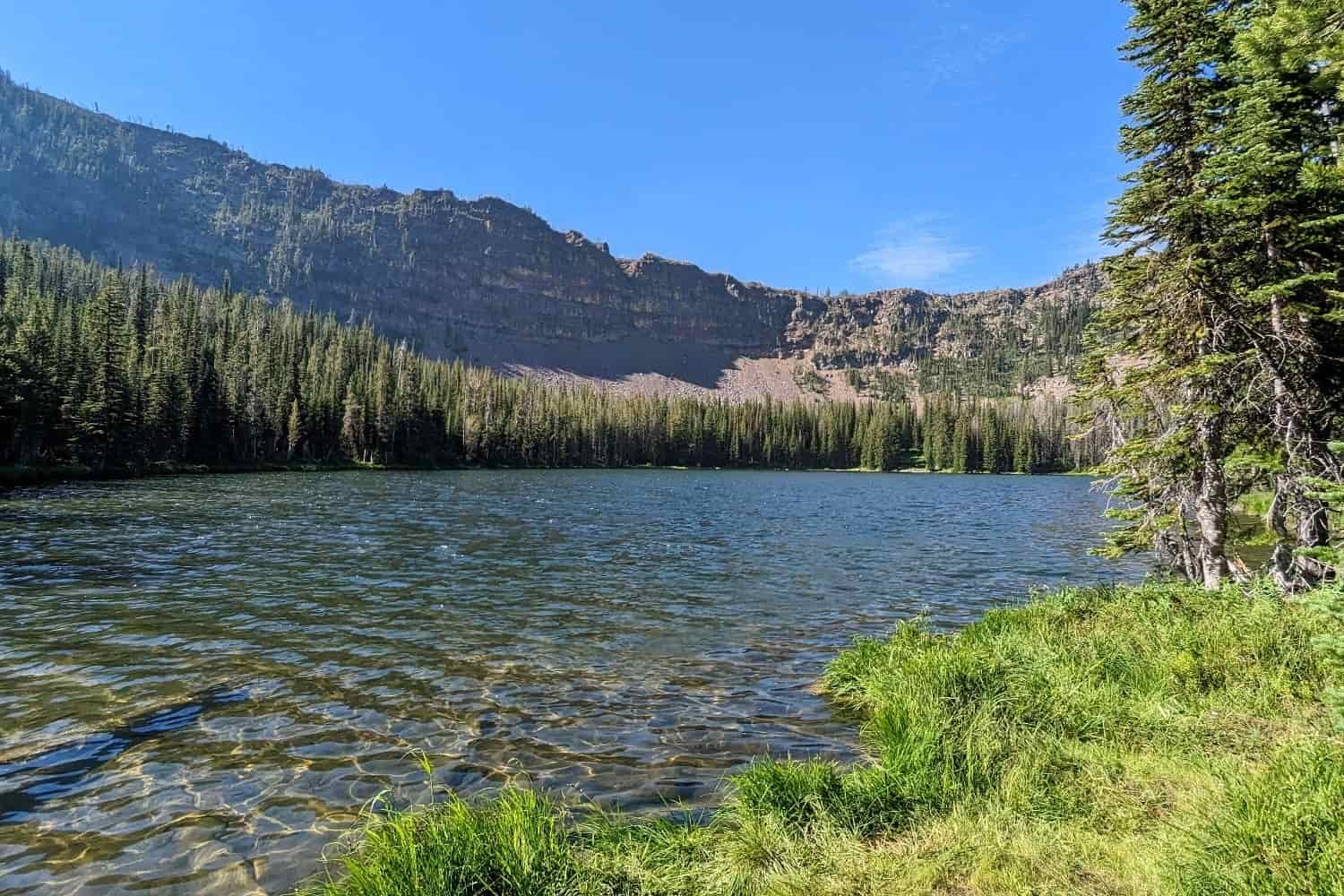 a lake beneath a cliffy cirque in eastern oregon