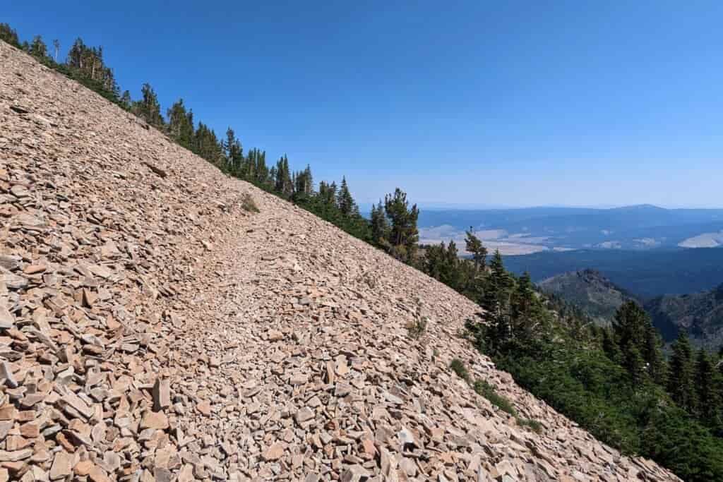a faint footpath through a steep scree field on the shoulder of Strawberry Mountain