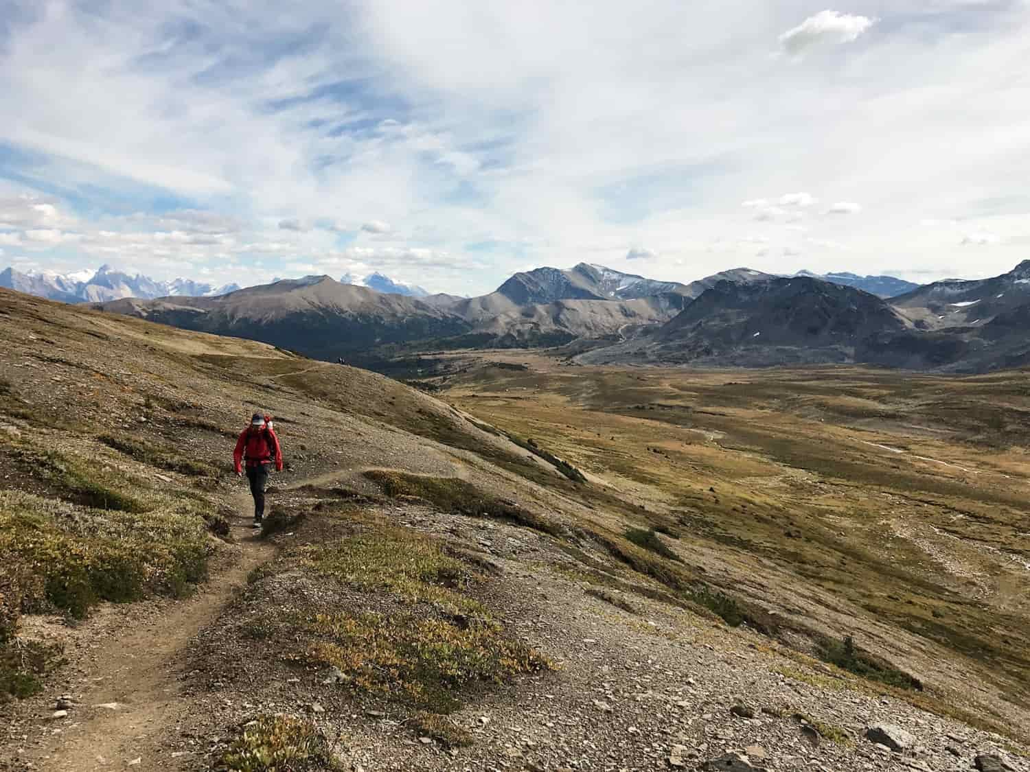 a backpacker walking through the mountains of jasper national park