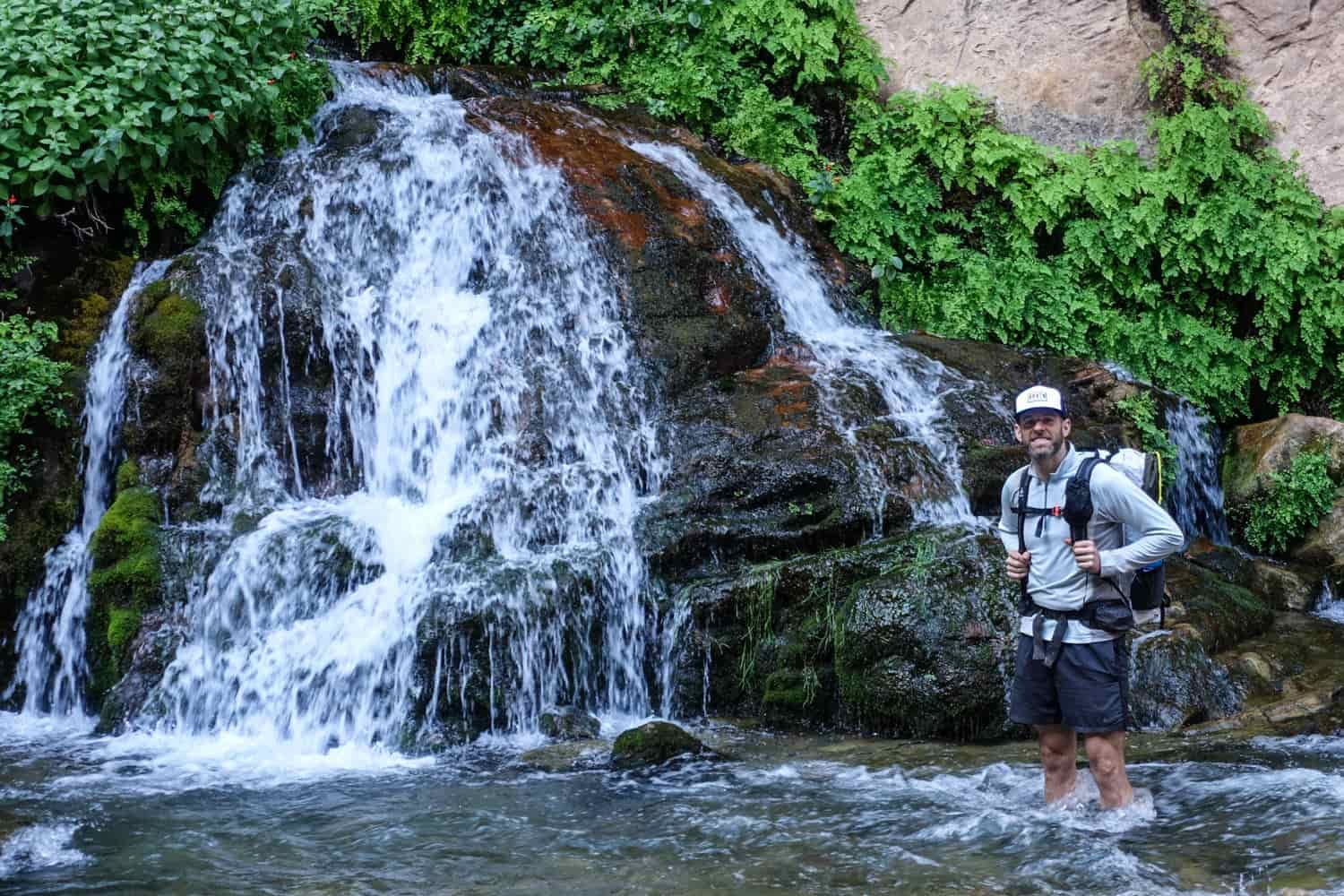 a hiker poses next to