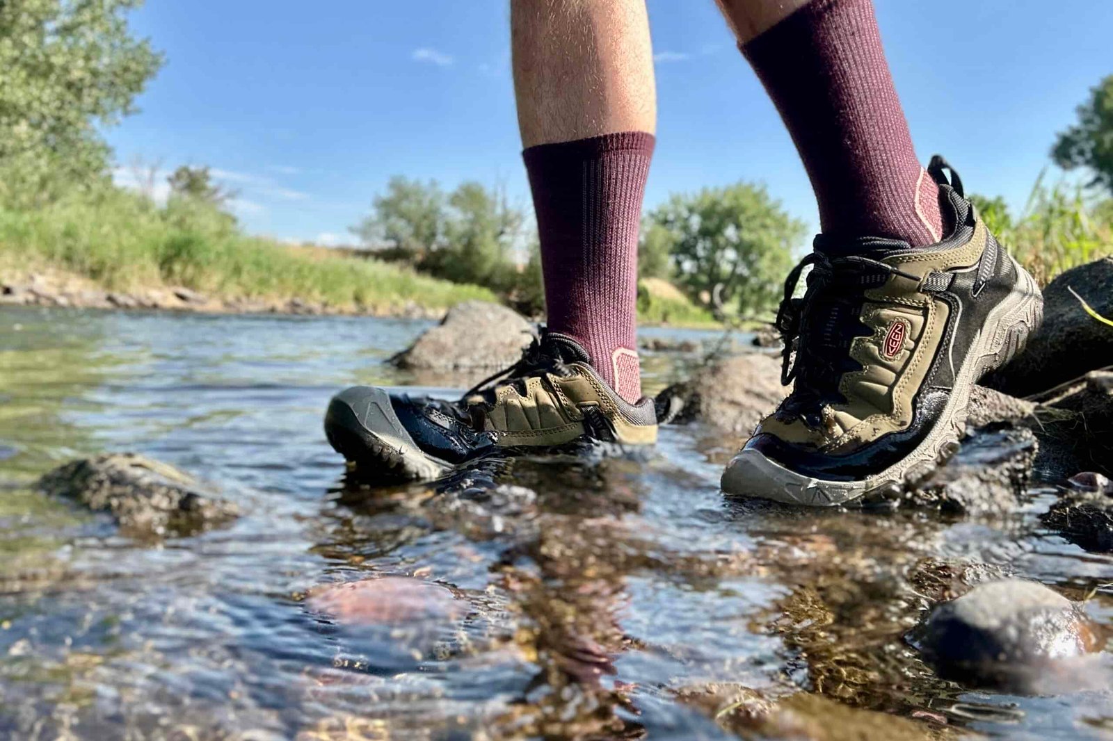 A close up view of the Keen Targhee IV hiking shoes from the side, partially submerged in water.