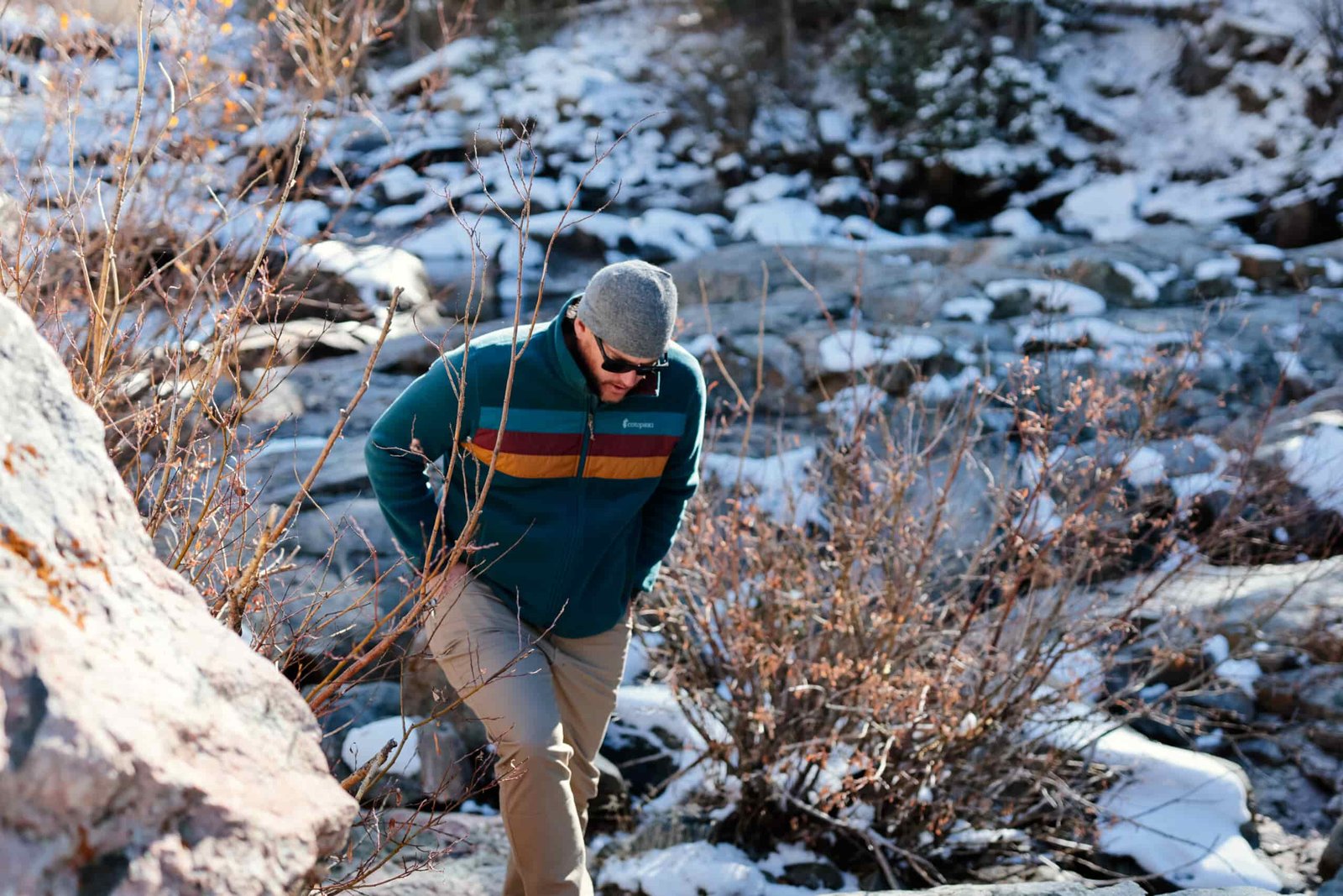 A man hikes up a snowy trail.