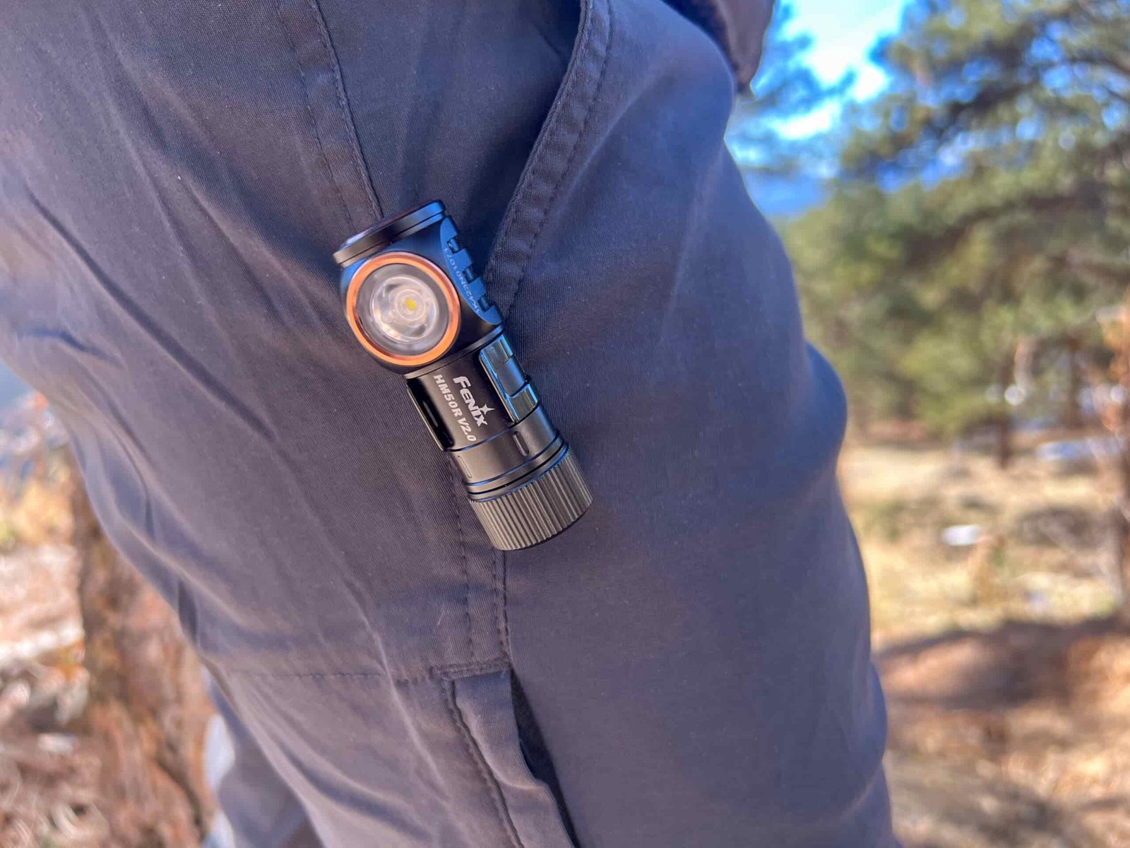 The image shows the HM50R V2.0 removed from it's star and clipped inside a hikers pants pocket.