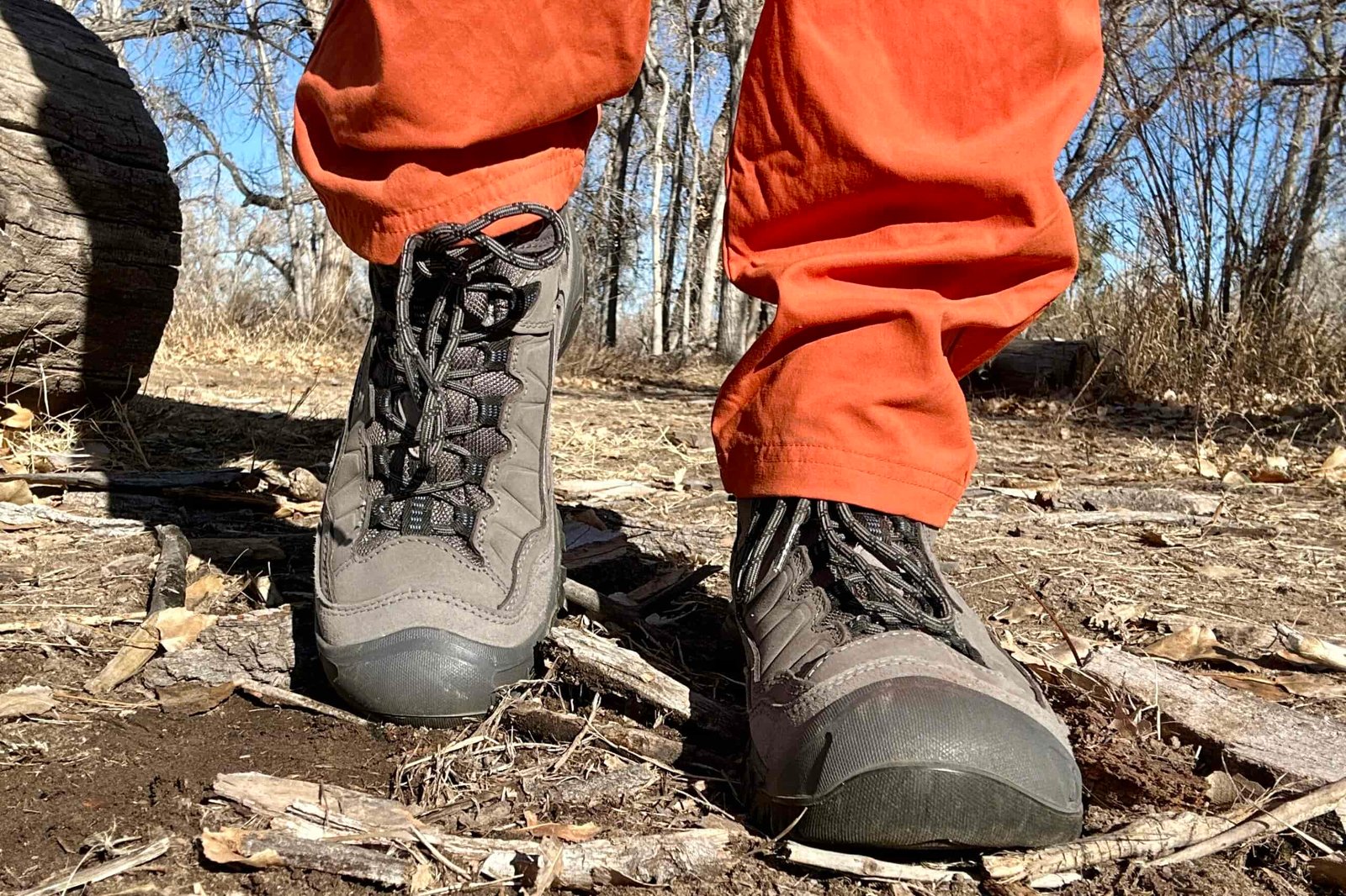 Close up image from knees down of hiking boots from the front.