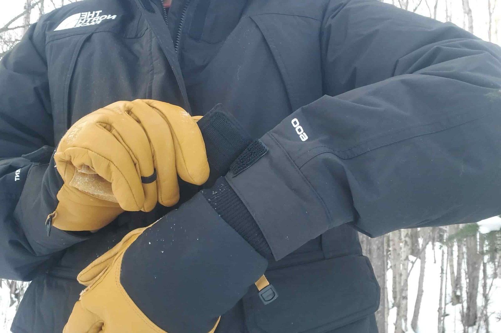A man tightens the cuffs on his jacket