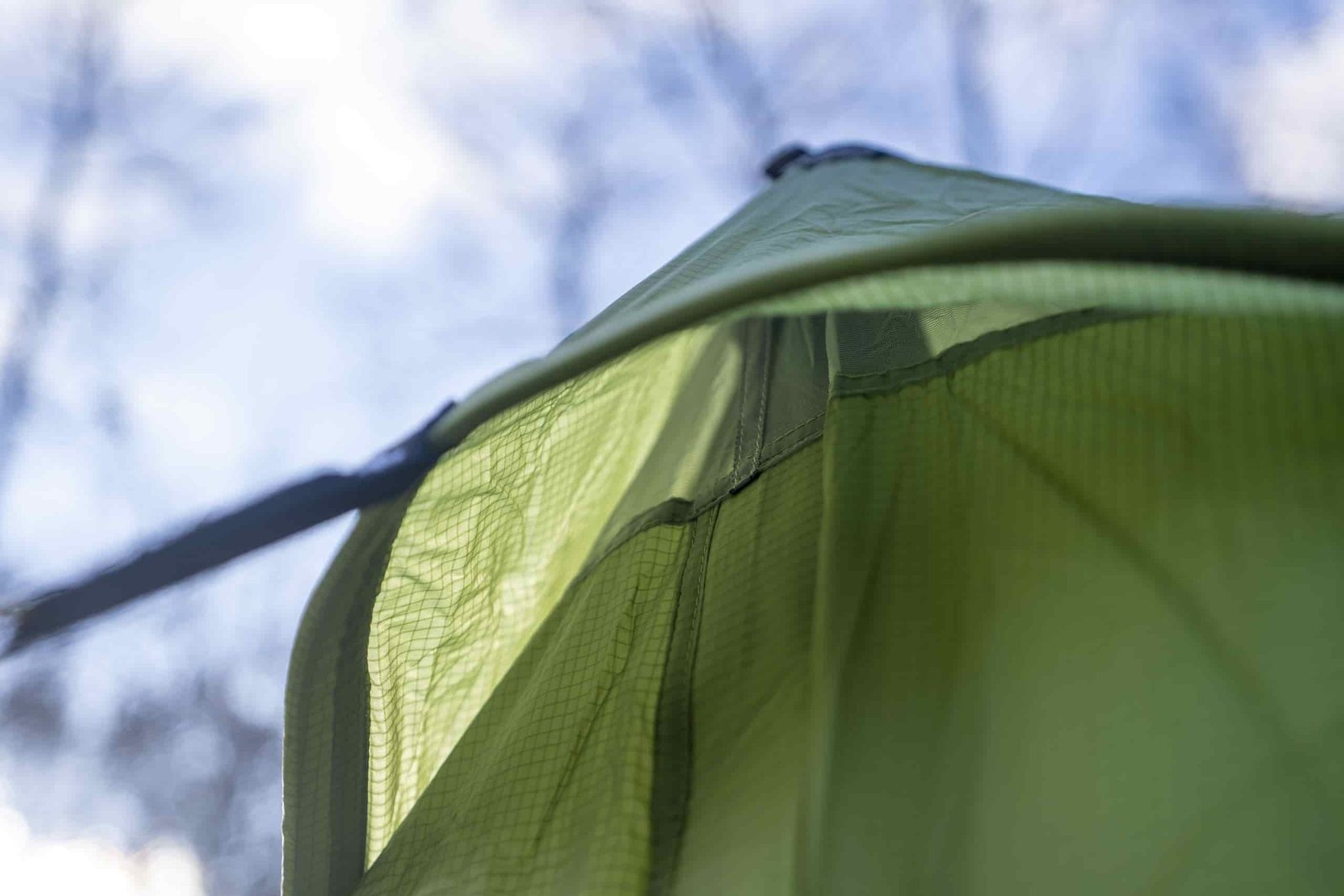 a view into a peak vent on a green tent