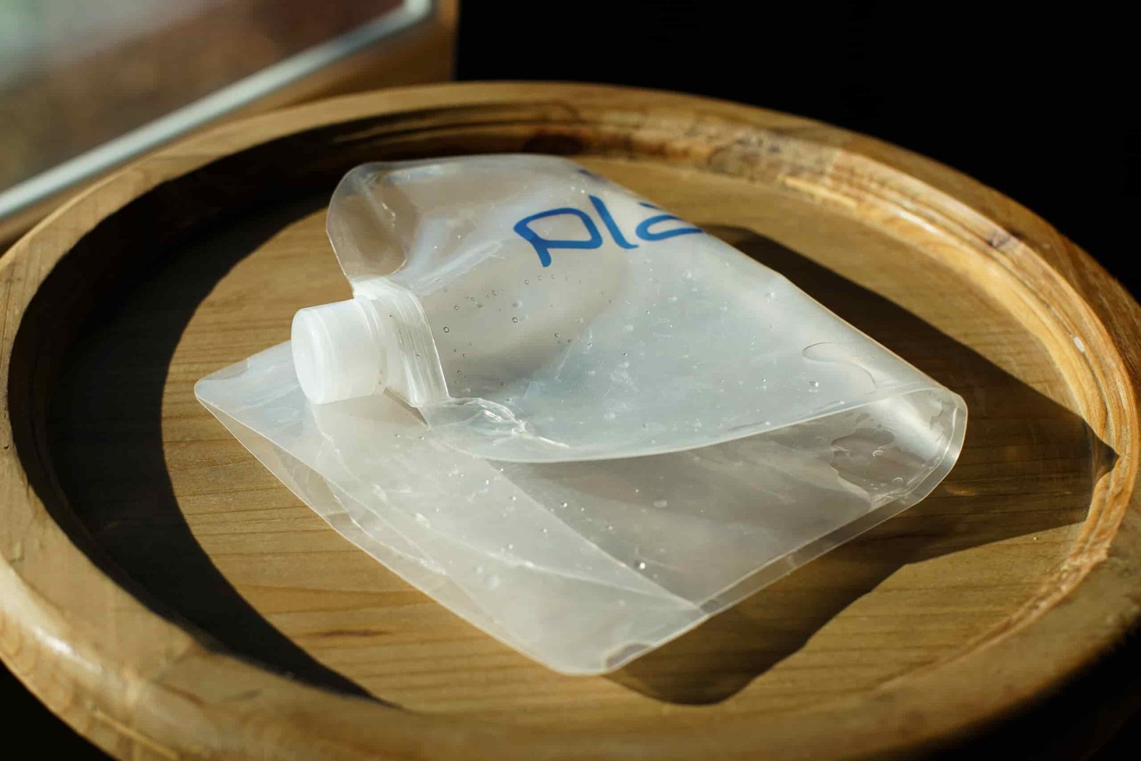 A close up of an empty Platypus Platy Bottle folded in half sitting on a table.