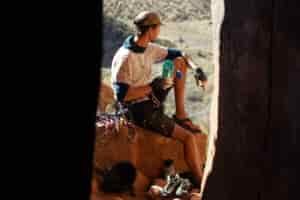 A person wearing a climbing harness holds the Nalgene Wide Mouth water bottle.
