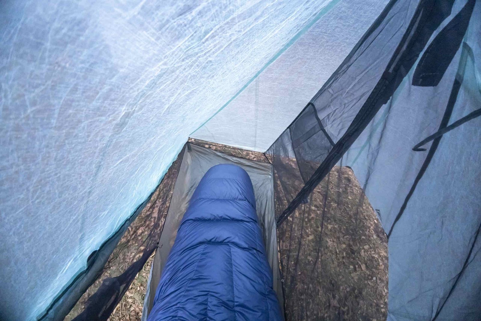 a first person view of a sleeping bag inside a one person tent