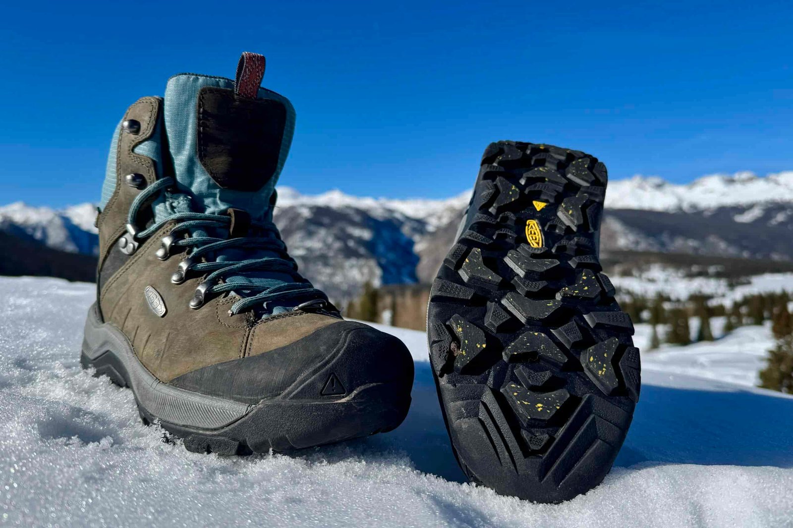 A close up of the tread on the bottom of the Keen boot. It is sitting in the snow in the mountains.