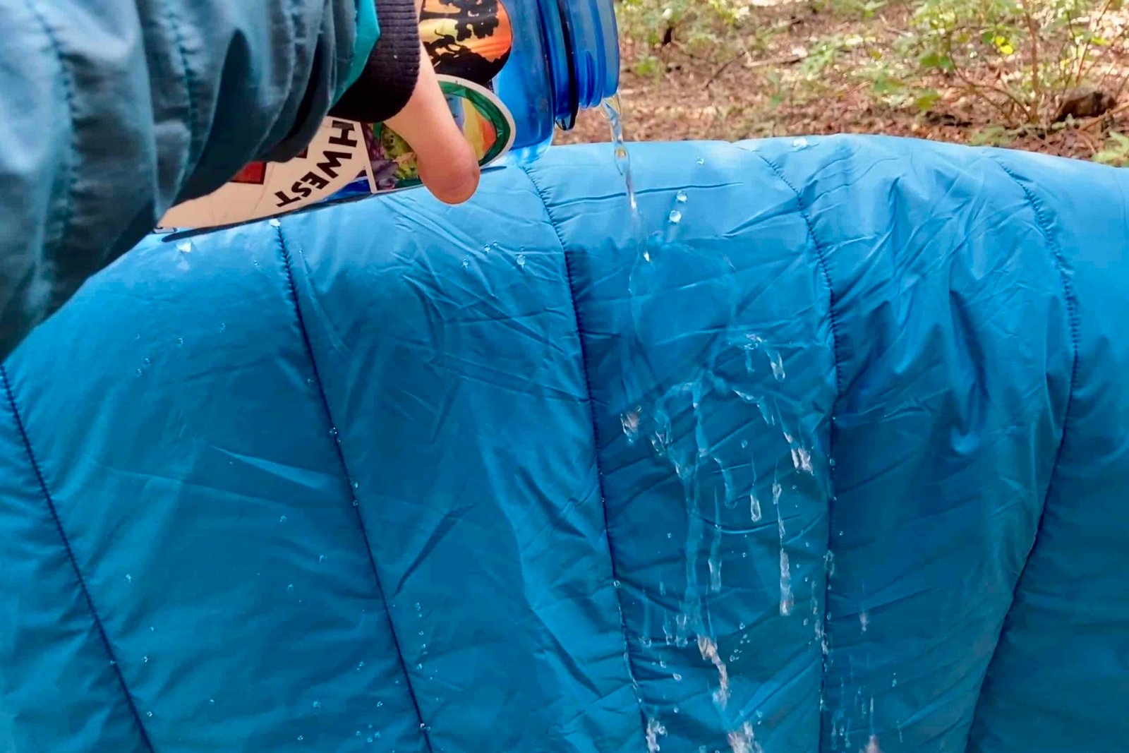 Pouring water over the REI camp blanket and it beads easily off the material