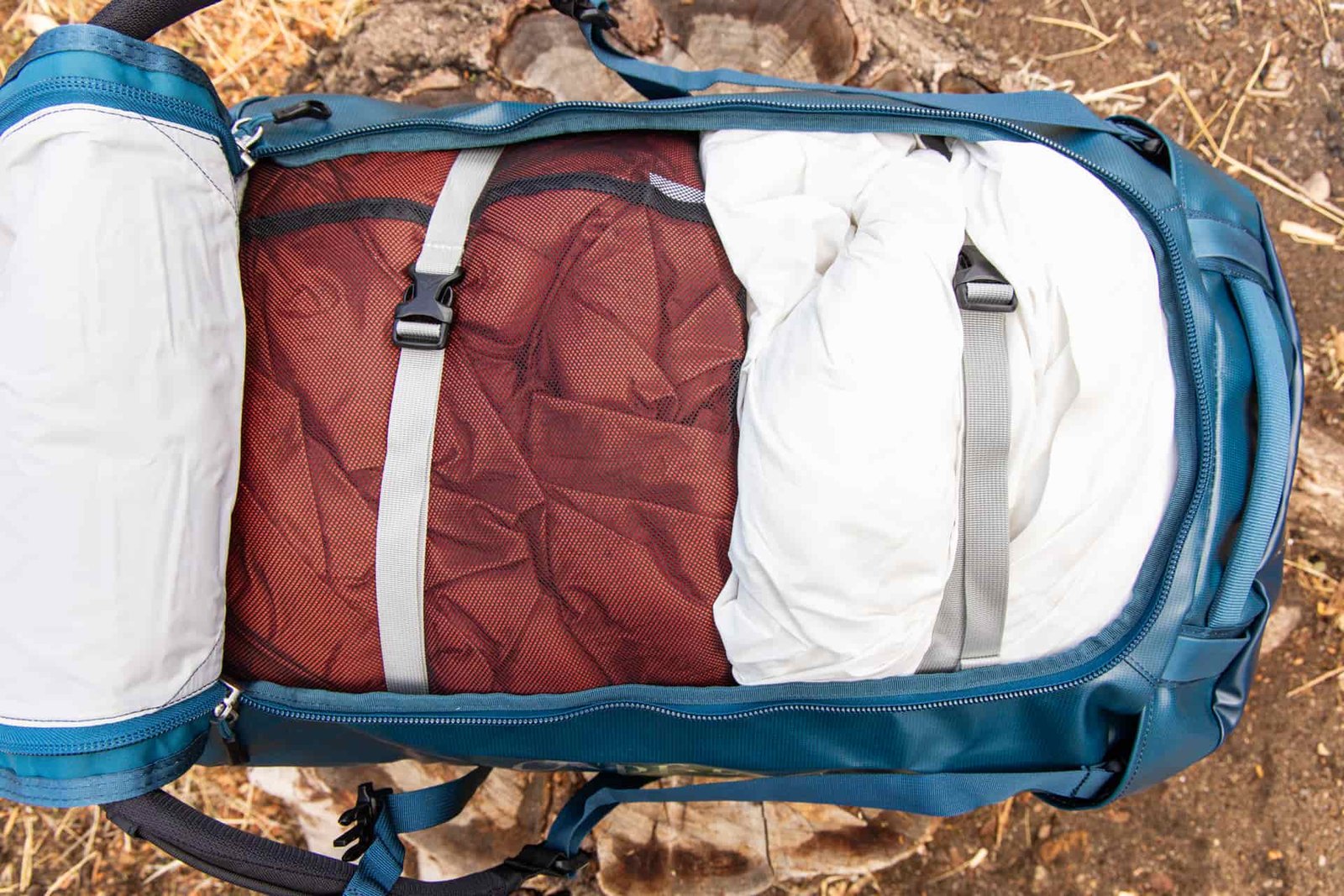 Interior compression straps cinched around two sleeping bags.