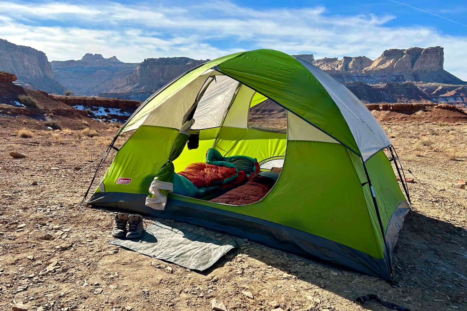 A tent setup in the desert under a blue sky.