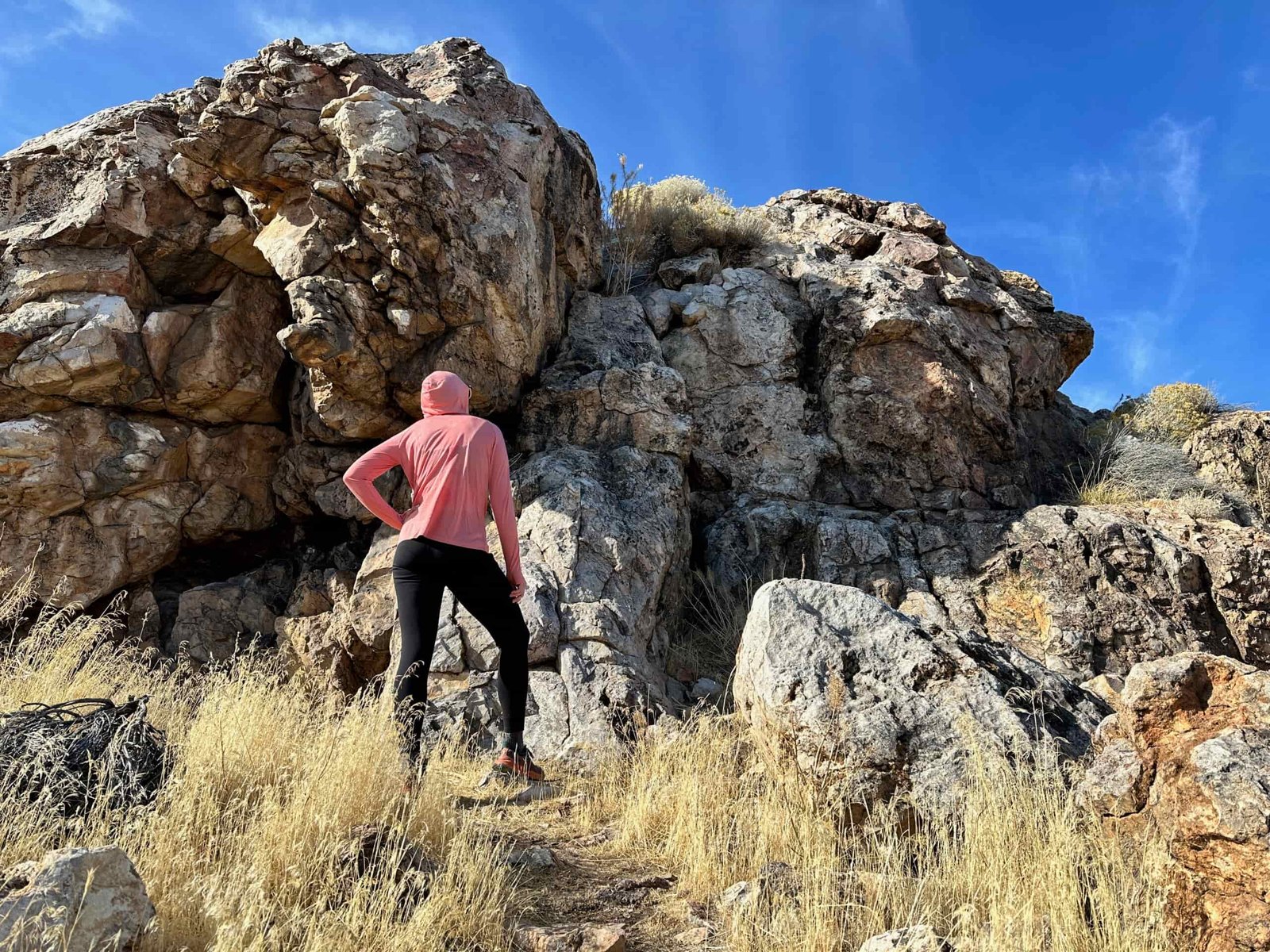 woman hiking with day pack in rocky high desert landscape