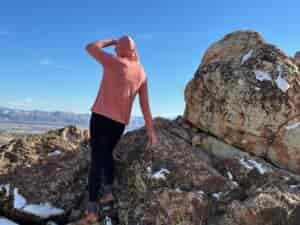 woman hiking with day pack in rocky high desert landscape