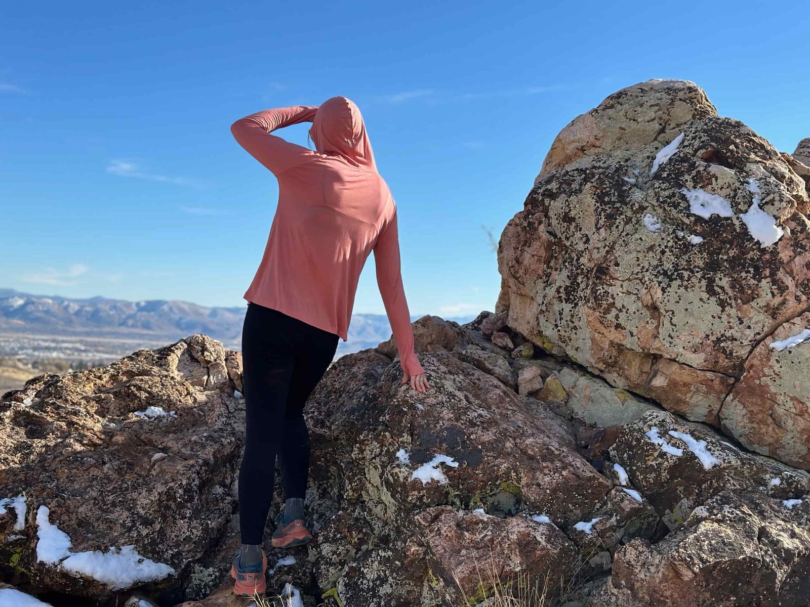 woman hiking with day pack in rocky high desert landscape