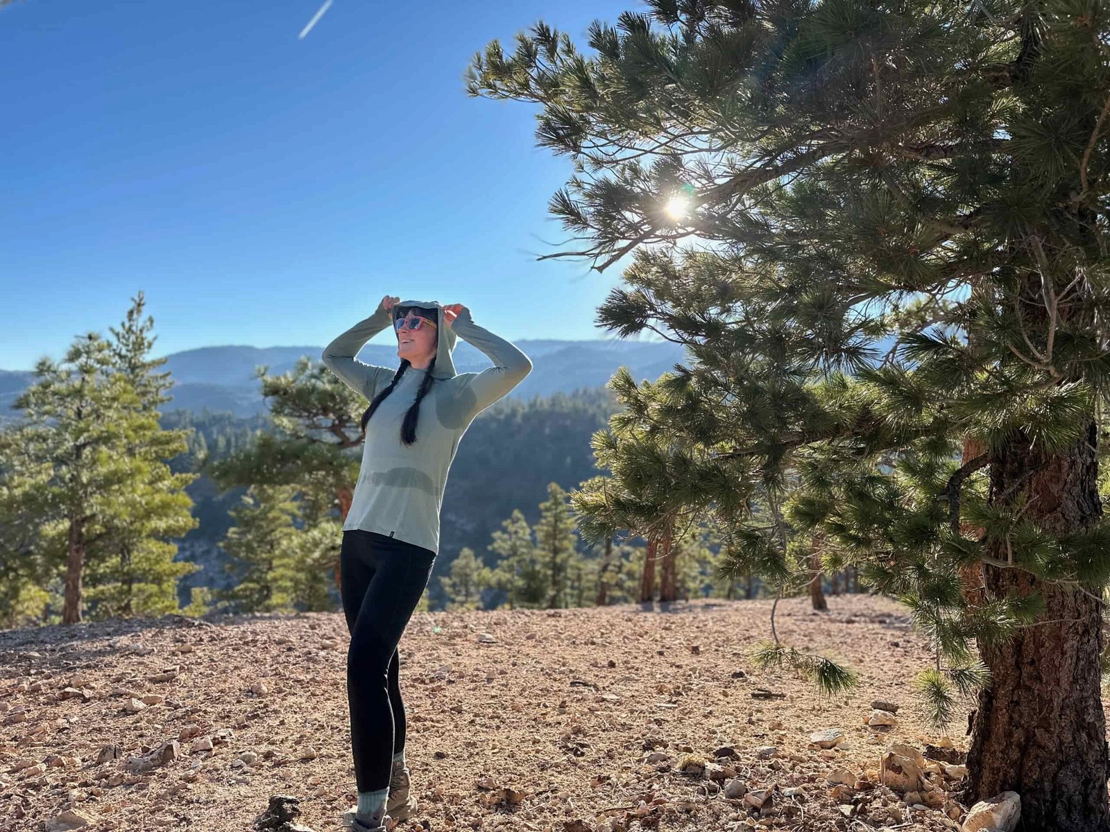 woman hiking with backpacking pack on in pine forest