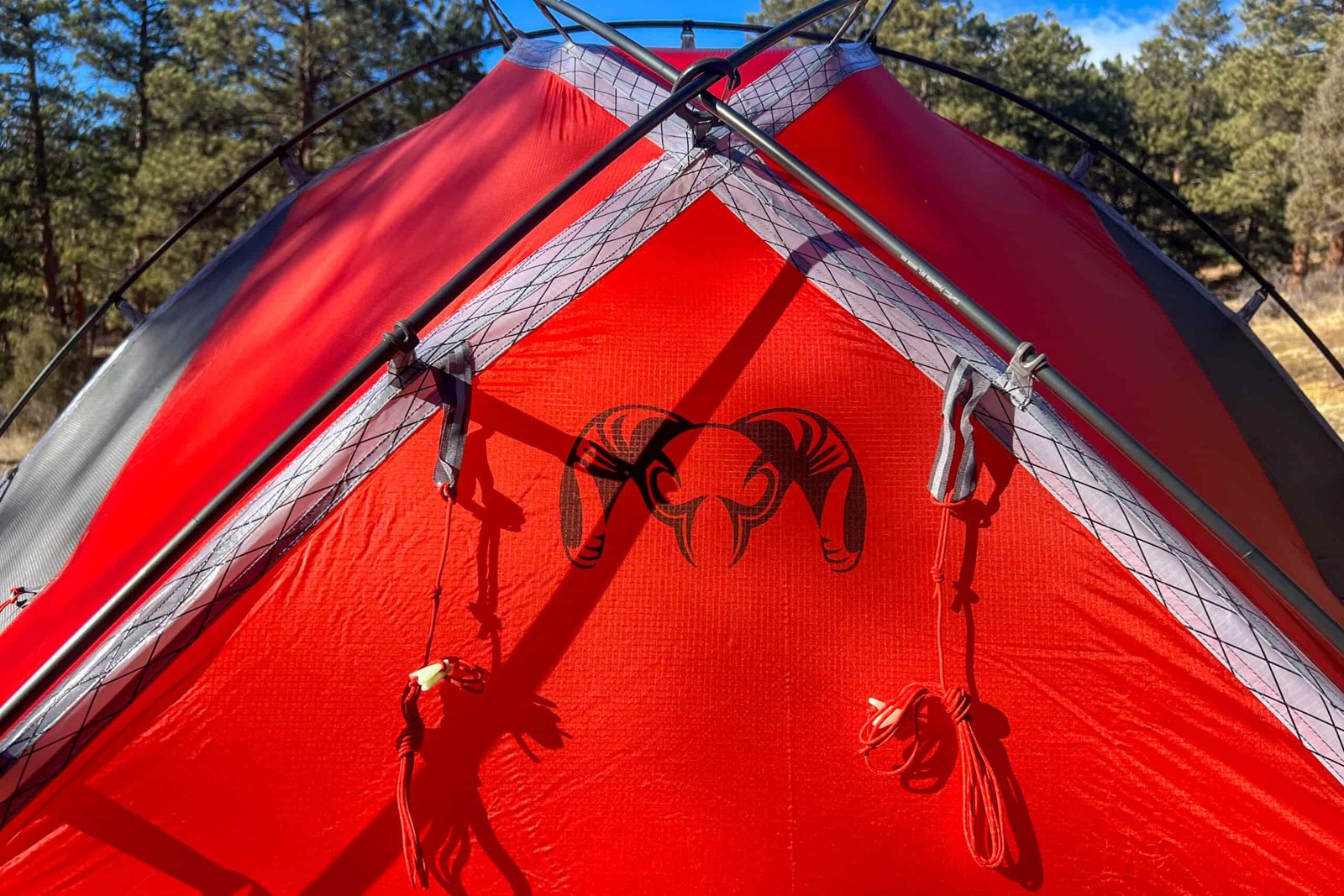 Detailed view of the KUIU Storm Star 2 tent’s ram logo and crisscrossed poles, highlighting its robust and stylish design.