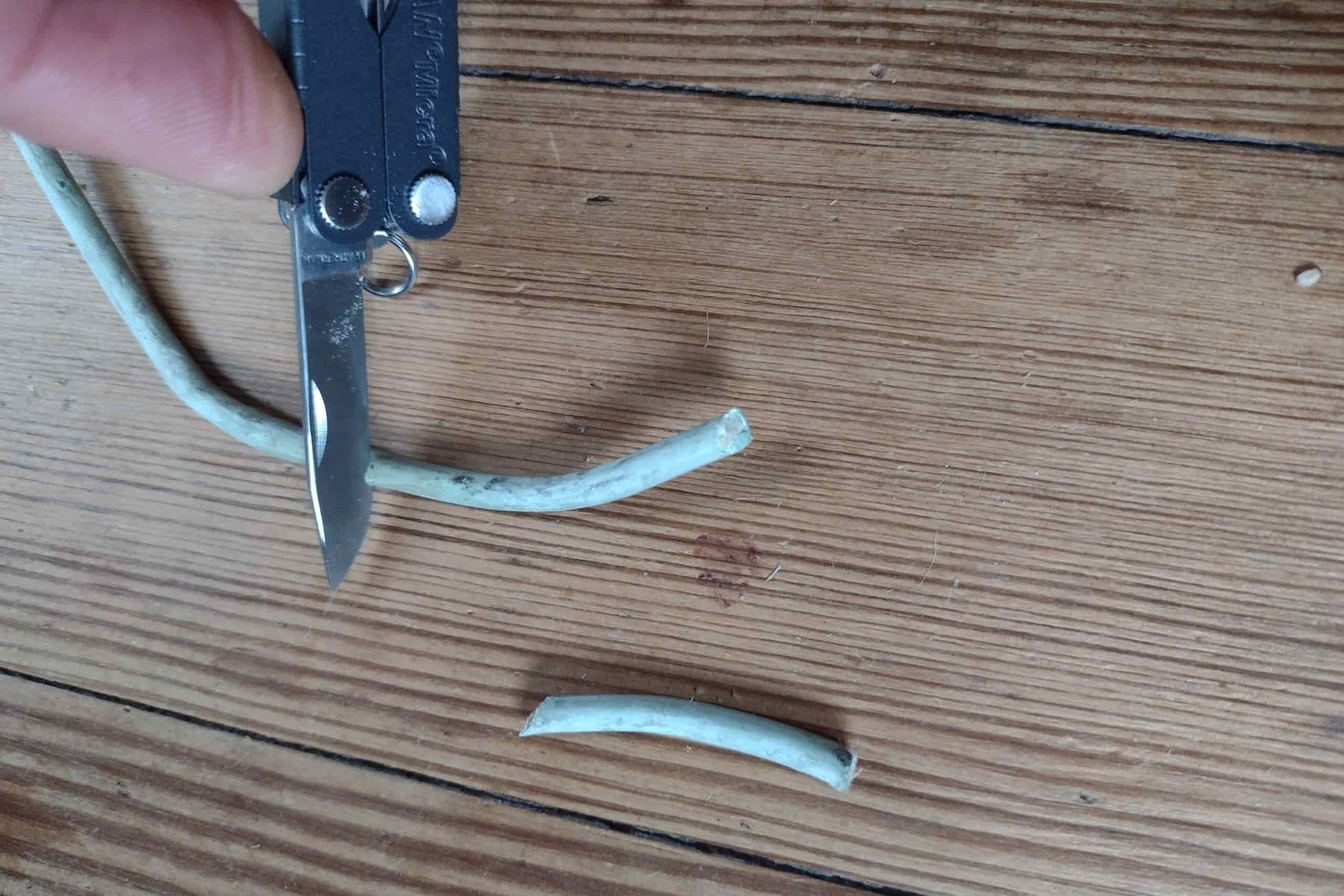 The Leatherman Micra cutting through small-gauge electrical wire.