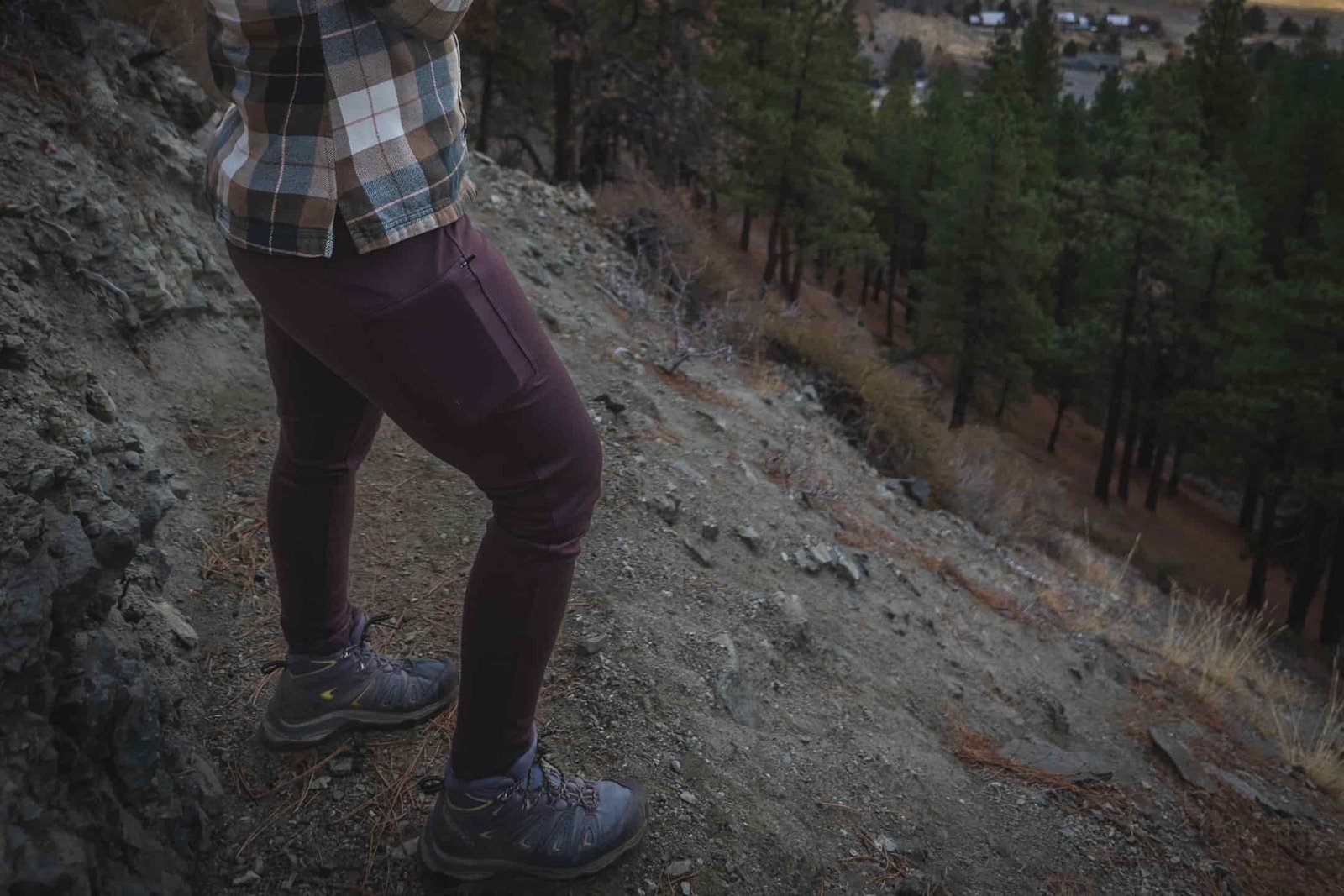 Woman on a hiking trail in rugged dark brown leggings.