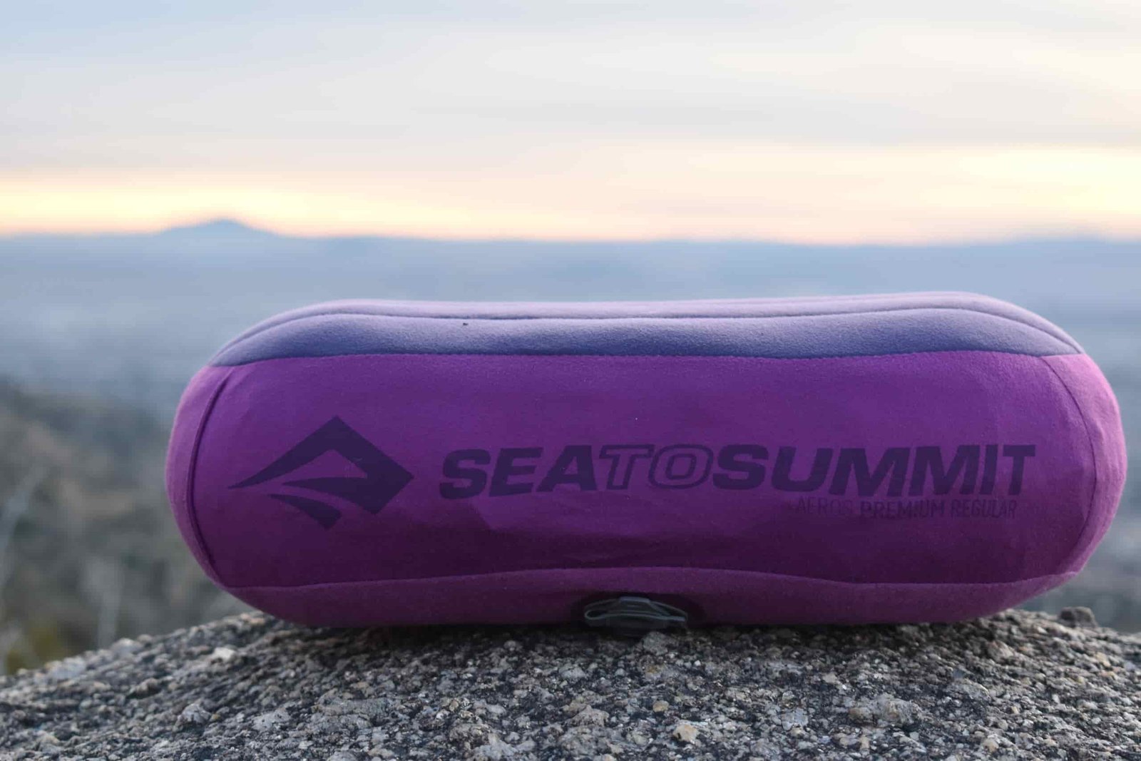 Close up of Aeros Premium Pillow on a boulder with the sunset in the background