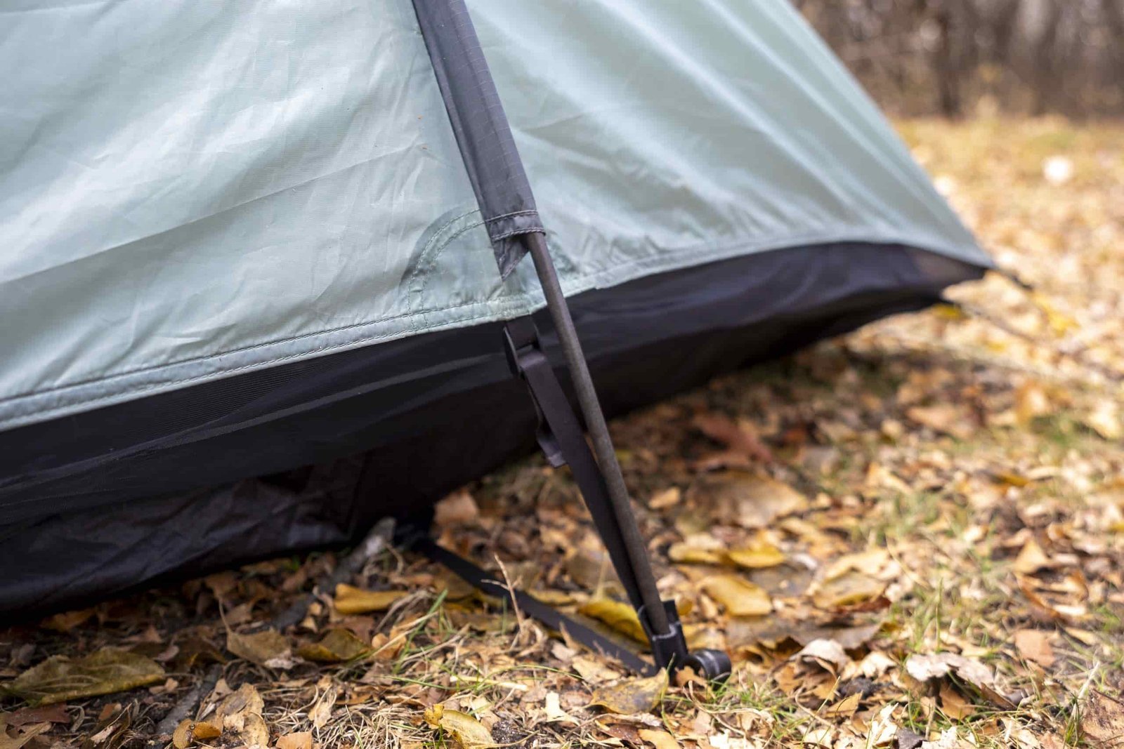 a tent pole contacts the ground on a tent
